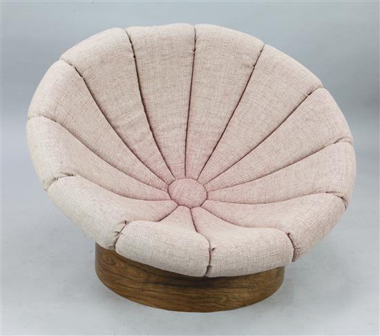 A mid 20th century Italian or Danish fibreglass and rosewood hemispherical lounge chair, Diam. 3ft 5in. H.2ft 1in.